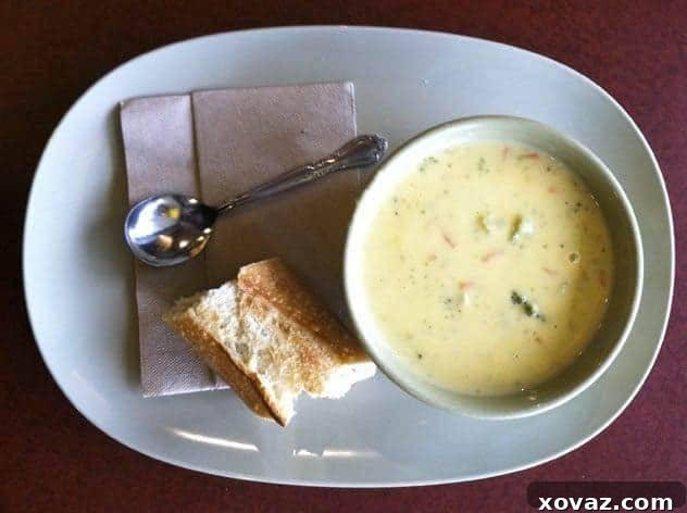 Panera Broccoli Cheddar Soup A rich bowl of Panera's Broccoli Cheddar Soup with a bread bowl
