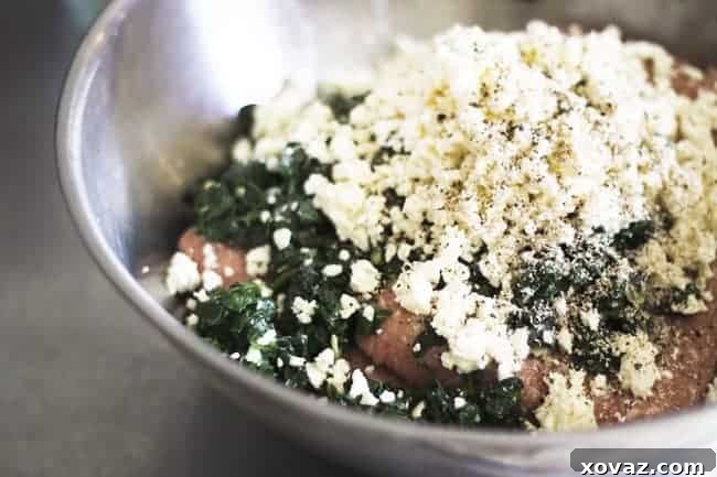 Mediterranean Spinach Feta Turkey Burgers 5 Mixture for Spinach Feta Turkey Burger – A bowl of ground turkey mixed with wilted spinach, feta cheese, and seasonings.