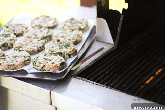 Mediterranean Spinach Feta Turkey Burgers 6 Ready to grill Spinach Feta Turkey Burger – Formed turkey burger patties on parchment paper, ready for grilling.