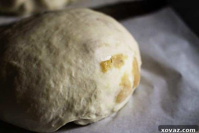 A perfectly formed, taut dough ball for Roasted Garlic Rustic Sourdough Boule, ready for its final proof.