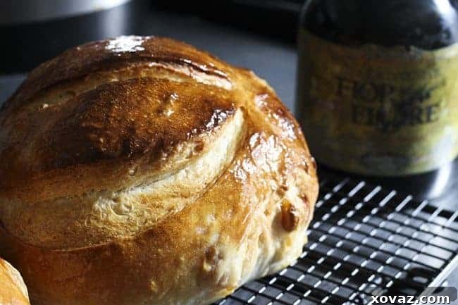 A beautiful Roasted Garlic Rustic Sourdough Boule, brushed with olive oil and sprinkled with sea salt for added flavor and a slightly softer crust.