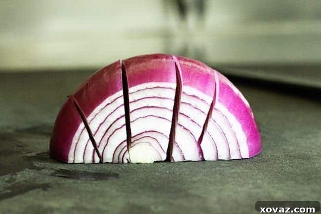 Thinly sliced red onion marinating in rice vinegar for the Marinated Broccoli Salad recipe.