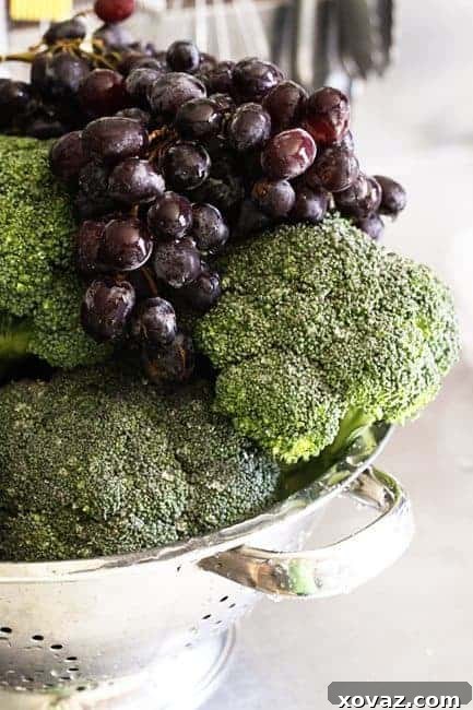 Fresh broccoli florets and juicy red grapes, key ingredients for the Marinated Broccoli Salad.