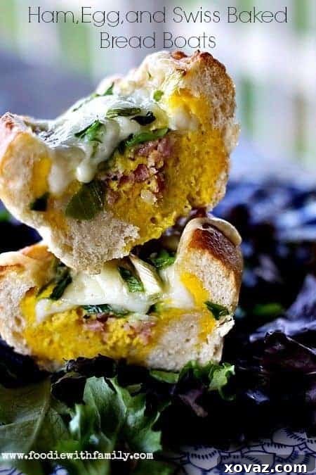 Ham, Egg, and Swiss Baked Bread Boats - Golden French rolls filled with savory ham, fluffy eggs, and melted Swiss cheese, ready to serve