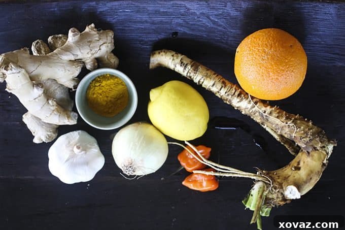 Homemade Fire Cider Elixir 4 Ingredients for Fire Cider laid out on a cutting board, including ginger, garlic, onions, citrus, and horseradish, ready for preparation.