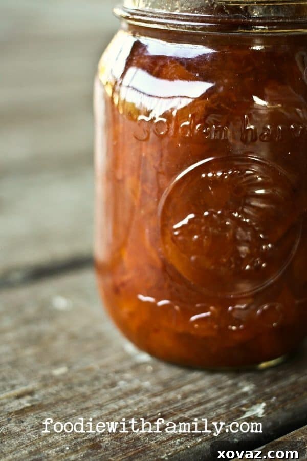 A jar of homemade Ginger Peach Preserves ready to be served or stored, a delicious canning project from foodiewithfamily.com