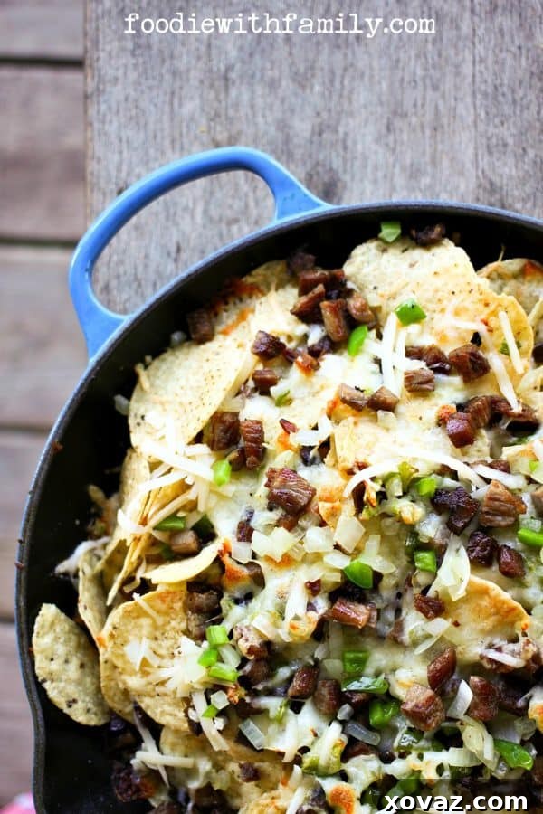 Ultimate Brisket Nachos 2 Cheesesteak Nachos are comfort food deluxe from foodiewithfamily.com beef, cheese, onions, peppers
