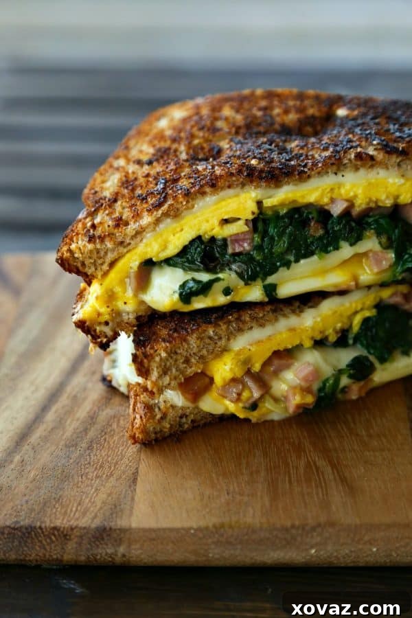 Cheesy Spinach Omelet Melt 2 Delicious Spinach Omelet Grilled Cheese Sandwich with melted Land O'Lakes cheese, perfect for a hearty breakfast or brunch, supporting Pin a Meal: Give a Meal program.