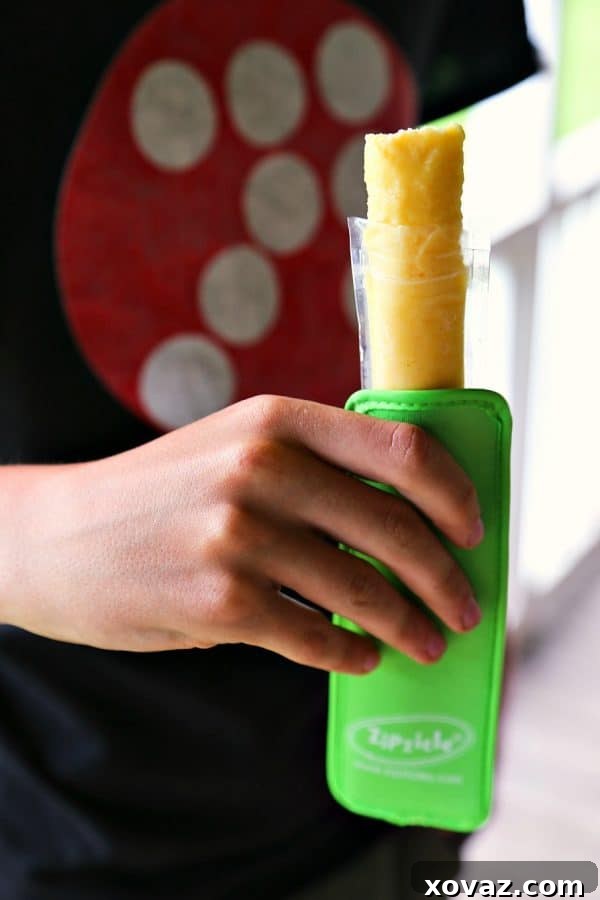 Homemade Ice Pops 4 Filling Zipsicle pouches with fruit juice for DIY Freezer Pops from foodiewithfamily.com