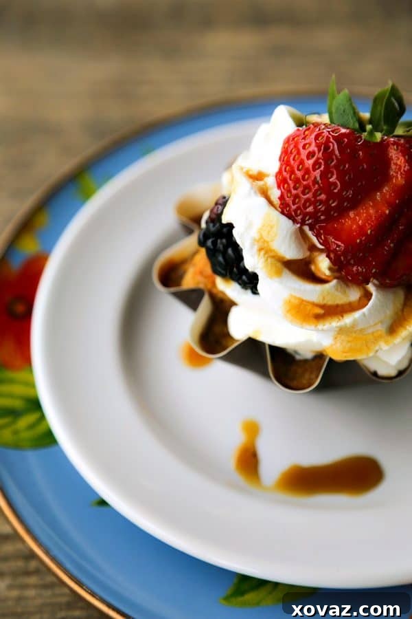 Serving Banana Bread French Toast Muffin Cups with fresh berries and maple syrup, an ideal breakfast or dessert from foodiewithfamily.com