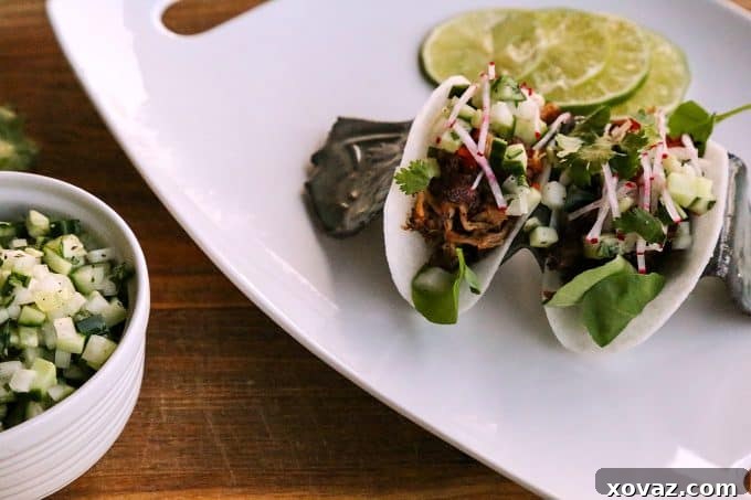 Jicama Tacos with carnitas, cucumber onion salsa, radishes, and cilantro.