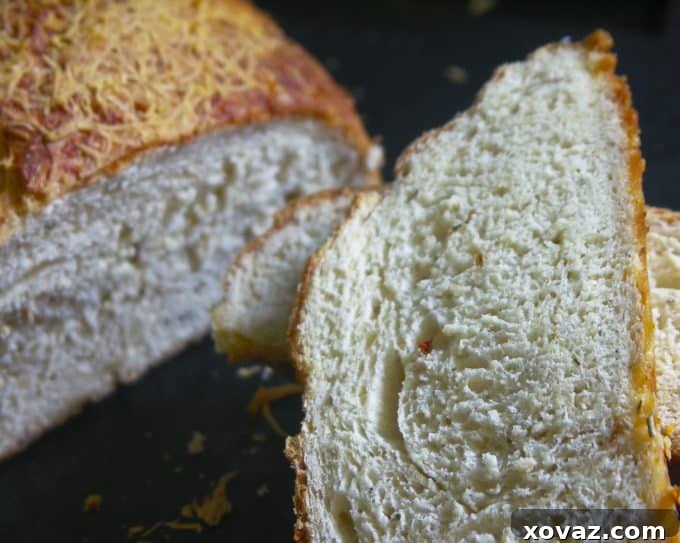 Cheesy Herb Garlic Bread Close-Up asiagoherbbread-20 - A close-up shot of the Asiago Herb and Garlic Bread, showing the bubbly cheese crust and herbaceous details.