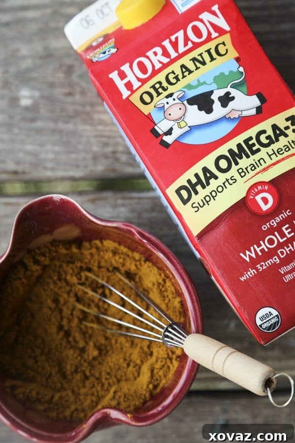 Close-up of Golden Honey Milk, rich in color from turmeric and spices, garnished with a sprinkle of cinnamon for a calming bedtime drink.