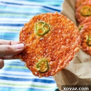 Round, crispy cheese crackers, fricos, 2-ingredient jalapeno popper crisps in paper bag, blue white and green tea towel