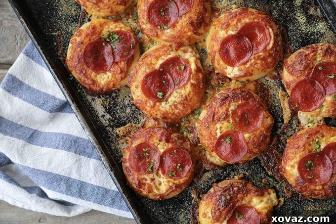 Cheesy Pepperoni Bialys Delights 3 Close-up of a Pepperoni Pizza Bialy, showcasing the golden-brown crust and bubbling cheese.
