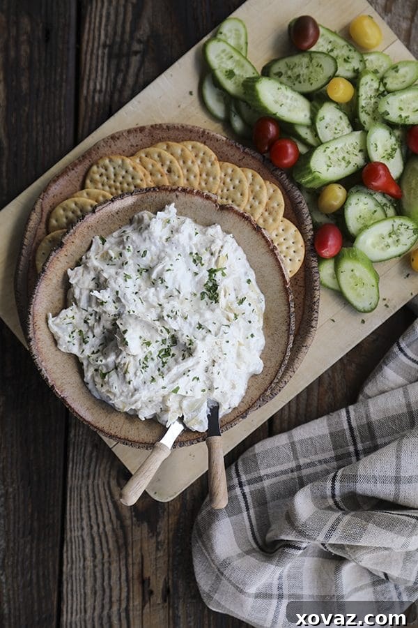 Velvety Roasted Garlic Artichoke Goat Cheese Dip 5 A close-up shot of warm Roasted Garlic Artichoke Goat Cheese Fondue, showing its smooth texture.