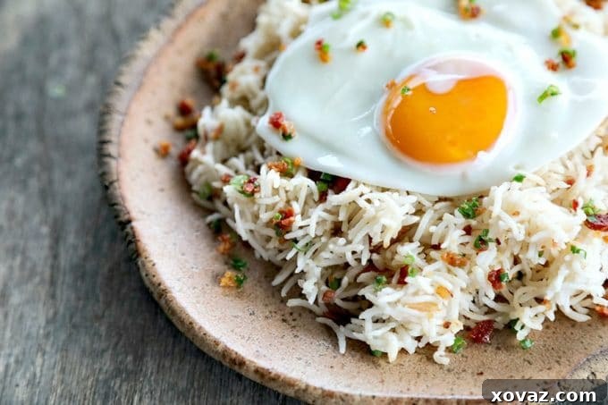Bacon Garlic Rice, a perfect side dish or light meal. Features fluffy basmati rice, savory bacon, and fresh green onions, ideal for pairing with various proteins or enjoying on its own.