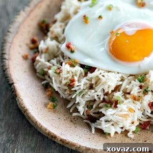 Bacon Garlic Rice: a savory and aromatic dish with crispy bacon, fried garlic, and fresh green onions mixed into fluffy basmati rice.