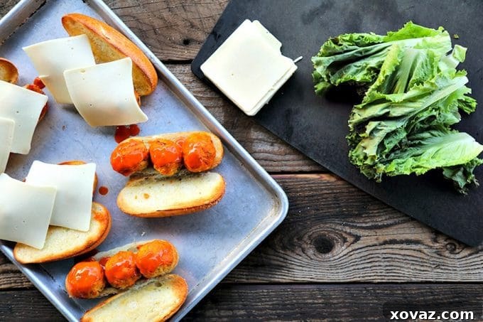 Legendary Buffalo Chicken Meatball Hoagie 3 Savory baked chicken meatballs infused with authentic Buffalo sauce, studded with finely diced celery, onions, and carrots, and blended with crumbled blue cheese. Served on toasted rolls with melted cheese, these subs are a game day essential.