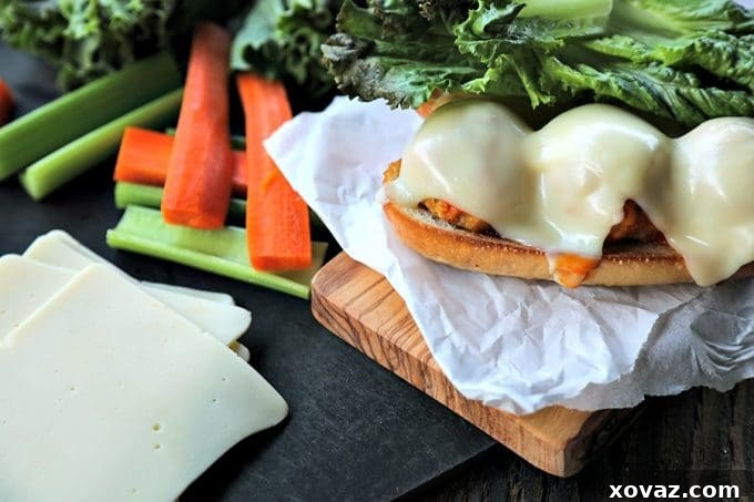 Legendary Buffalo Chicken Meatball Hoagie 5 A close-up of a prepared Ultimate Buffalo Chicken Meatballs Sub, showcasing the rich, saucy meatballs, melted cheese, and fresh lettuce in a toasted roll. Ready for game day feasting!