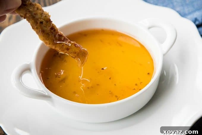 A close-up shot of the Crispy Pork Tenders as they are being deep-fried to a perfect golden brown in hot oil.