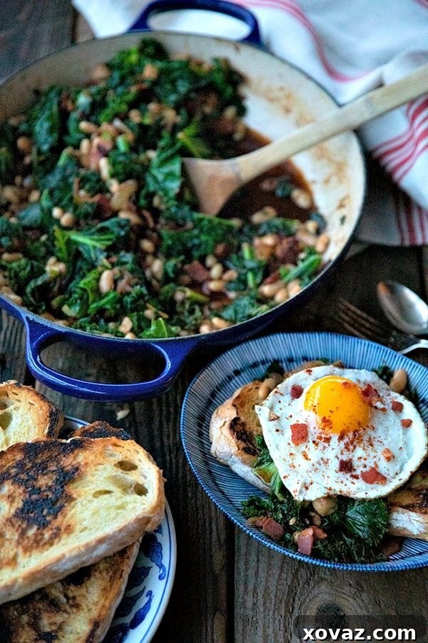 Tender beans and greens, caramelized onions, savory bacon, sliced garlic, smoked paprika, and a hint of spice, star in this one-pot, low cost, crowd-pleaser served over indulgently thick slices of crunchy-edged, pan toasted garlic bread.