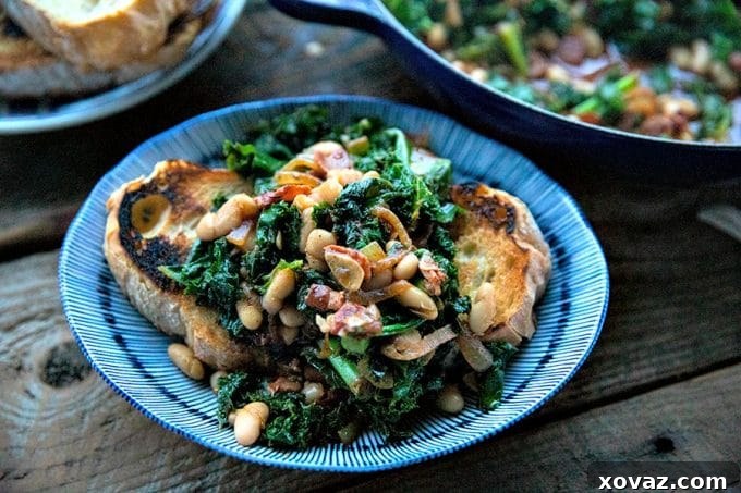 Close-up of the hearty beans and greens dish, highlighting the tender beans, green leaves, and savory bacon bits.
