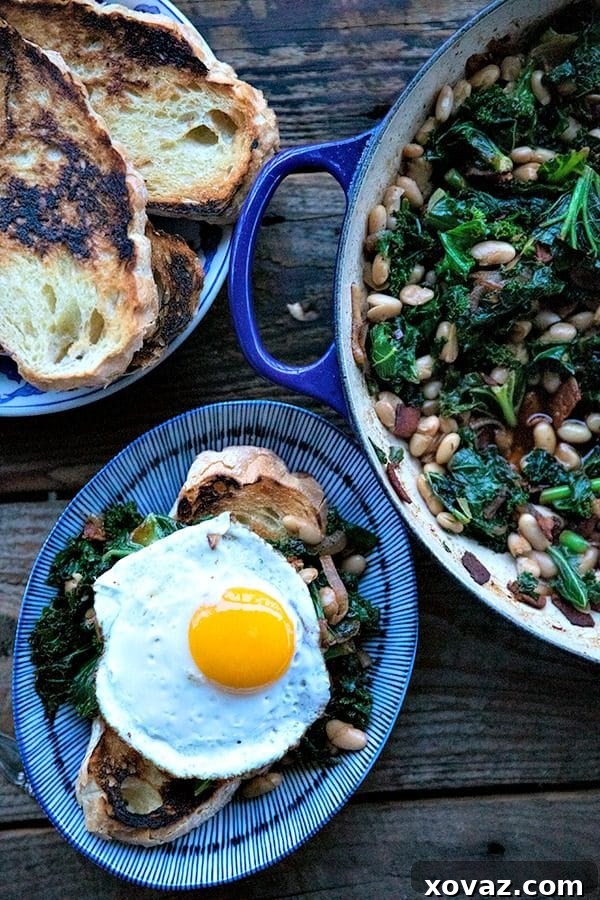 Tender beans and greens, caramelized onions, savory bacon, sliced garlic, smoked paprika, and a hint of spice, star in this one-pot, low cost, crowd-pleaser served over indulgently thick slices of crunchy-edged, pan toasted garlic bread.