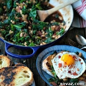 Tender beans and greens, caramelized onions, savory bacon, sliced garlic, smoked paprika, and a hint of spice, star in this one-pot, low cost, crowd-pleaser served over indulgently thick slices of crunchy-edged, pan toasted garlic bread.