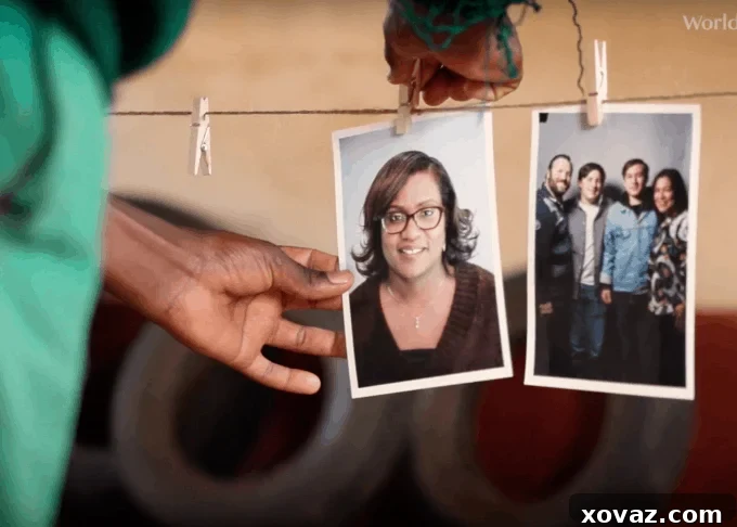 A young girl smiling brightly, holding a photograph of a potential sponsor she has chosen, symbolizing hope and agency through World Vision's #Chosen initiative.