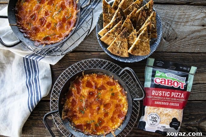 Scooping Pizza Dip with a pita wedge