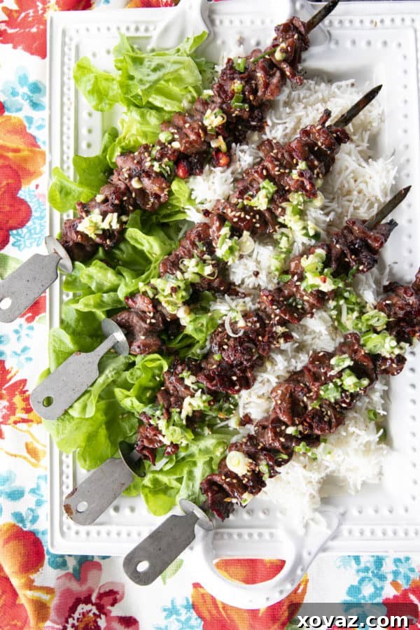 Slices of flat iron steak marinating in a rich Korean barbecue sauce, ready for grilling or broiling.