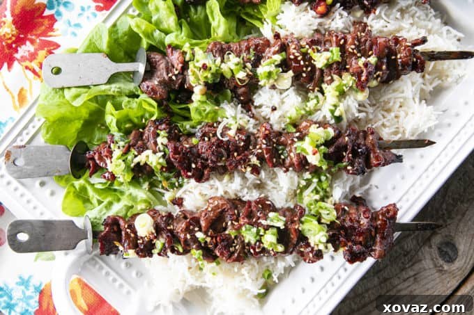 A vibrant platter of Korean Barbecue Grilled Flat Iron Steak, ready to be served with traditional side dishes.