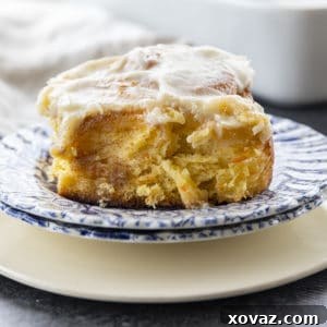 Carrot Cake Cinnamon Rolls are big, FLUFFY AS A CLOUD, & positively studded with super fine shreds of sweet carrots before being rolled up around a spiced buttery brown sugar filling.
