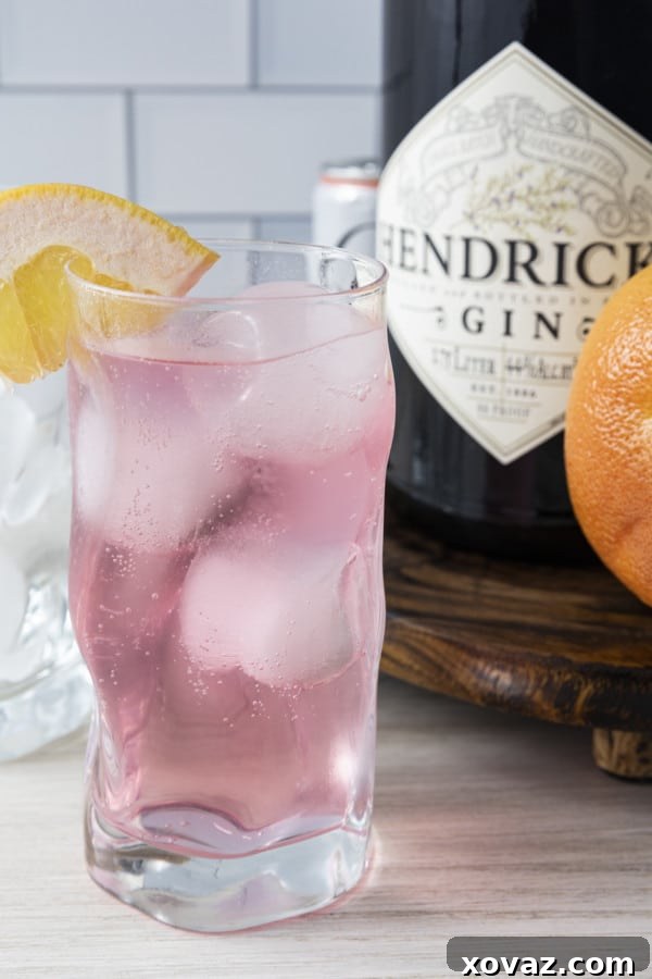 A perfectly prepared Finnish Long Drink, combining citrus soda and gin, garnished with a fresh grapefruit slice, ready to be enjoyed.