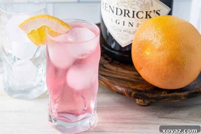 Close-up of a refreshing Finnish Long Drink in a stylish tumbler, garnished with a grapefruit wheel.