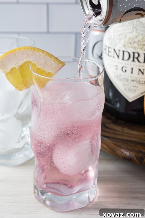 Ingredients for a Finnish Long Drink laid out: gin, grapefruit soda, ice, and garnishes.