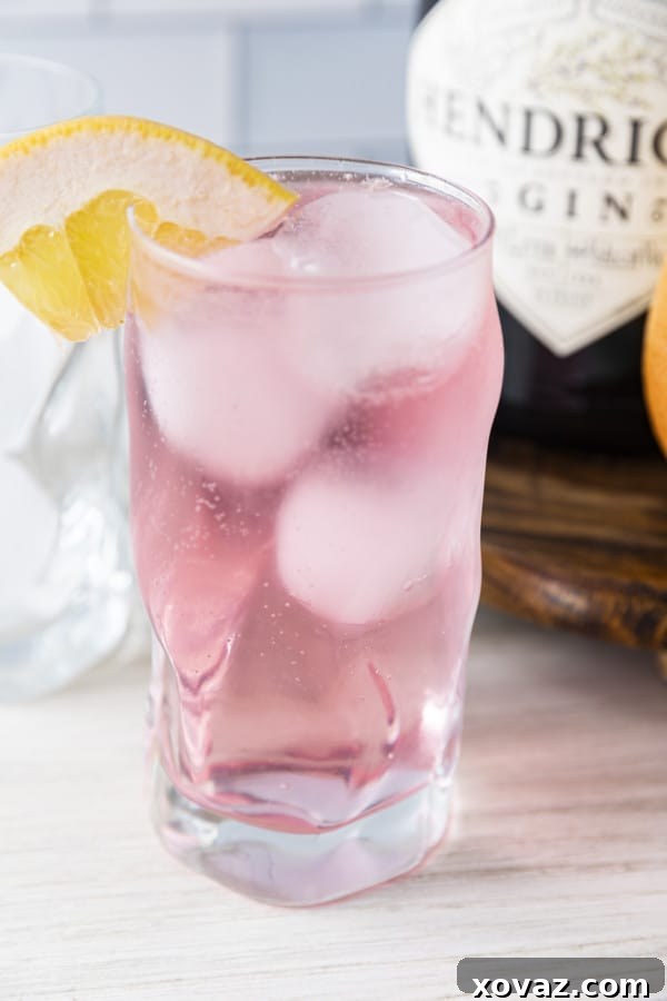 Two glasses of Finnish Long Drink, garnished with lime and grapefruit slices, ready to be enjoyed on a warm day.