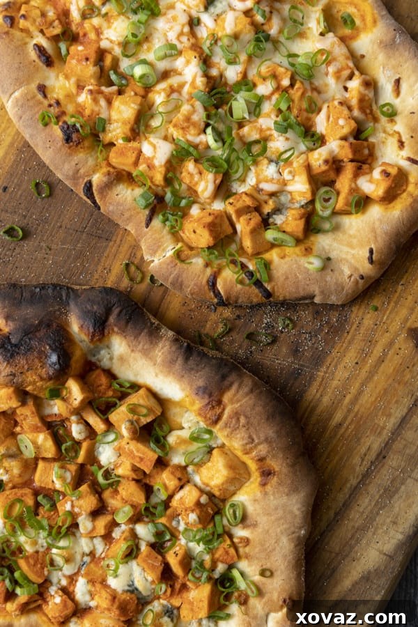 Bold Buffalo Chicken Flatbread 3 A close-up of a freshly baked Buffalo Chicken Flatbread, showcasing the crispy crust and generous toppings.