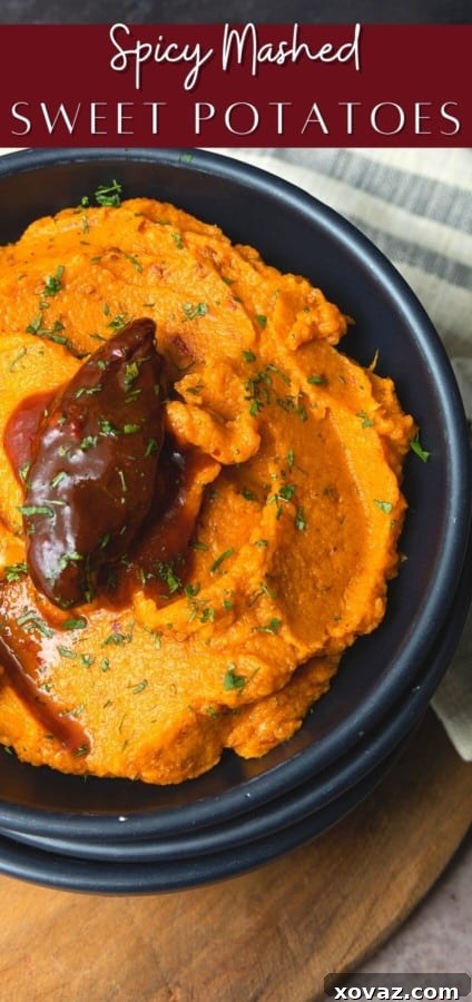 Sweet Potato Chili Delight 6 A large bowl of fluffy, vibrant orange spicy sweet potato mash, generously garnished with fresh green cilantro leaves.