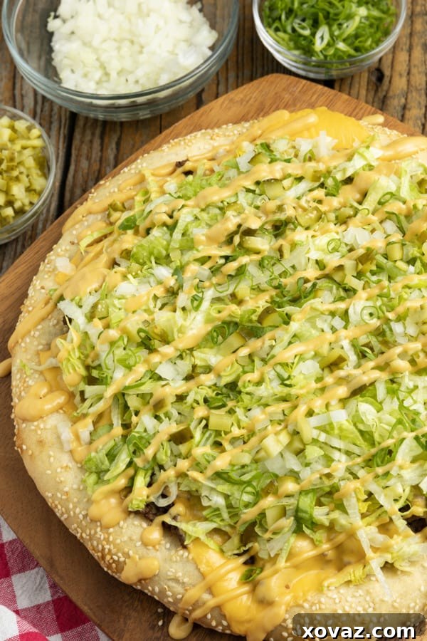 Mac Attack Pizza 4 A selection of fresh ingredients laid out for making Big Mac Pizza, including ground beef, lettuce, pickles, and cheese