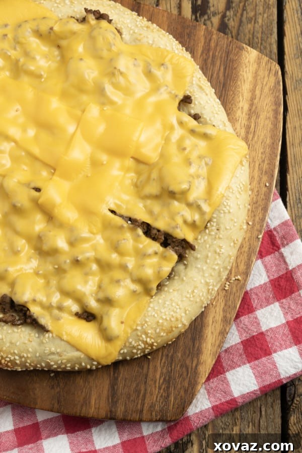 Mac Attack Pizza 5 Pre-baked pizza crust brushed with olive oil and sprinkled with sesame seeds, ready for toppings