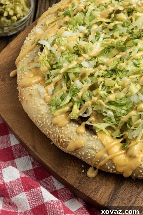 Mac Attack Pizza 6 A slice of Big Mac Pizza being lifted from the whole pizza, showing its generous toppings and crispy crust