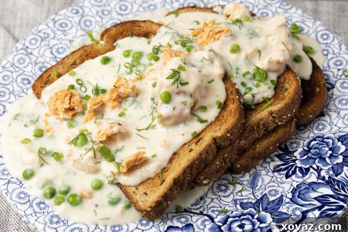 Creamy salmon sauce, rich and thick, simmering gently in a saucepan, ready to be served.