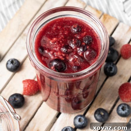 A vibrant bowl of berry compote, glistening and ready to serve.