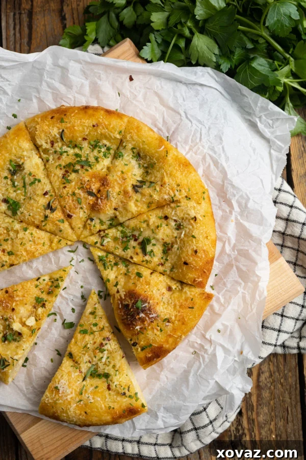 Ultimate Garlic Pizza 2 A golden-brown garlic pizza, brushed with garlic oil, sprinkled with Parmesan cheese and red pepper flakes, showcasing its blistered, crispy crust and irresistible appeal.