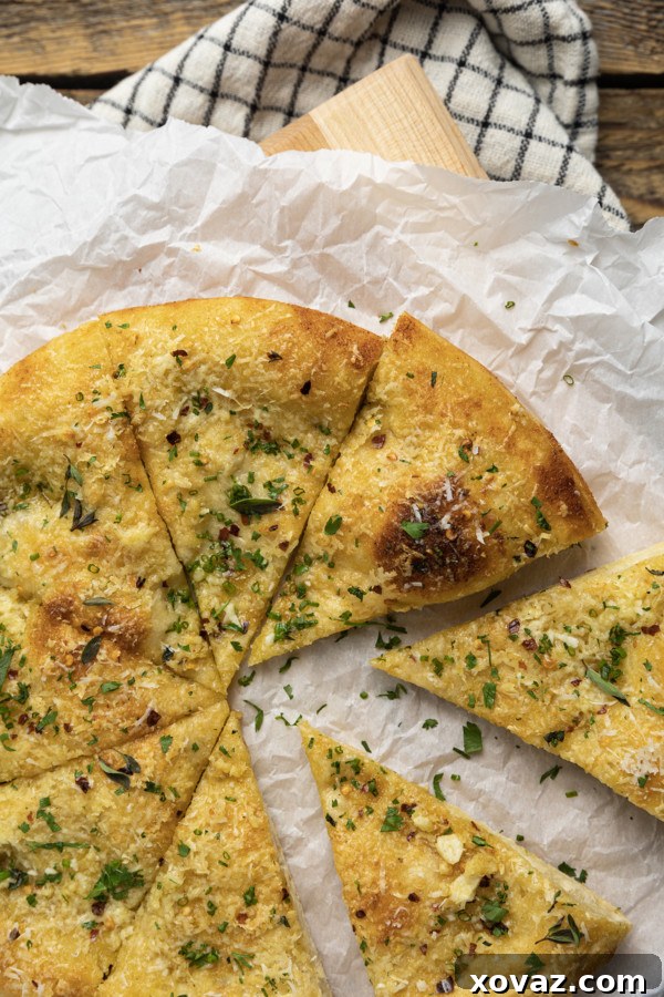 Ultimate Garlic Pizza 4 A perfectly baked garlic pizza, showcasing its golden-brown, bubbly crust, topped with fragrant garlic and herbs, ready to be sliced and served.