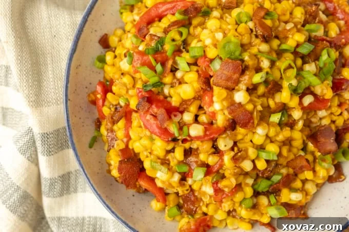 Skillet-Fried Sweet Corn 2 fried sweet corn with bacon, green onions and roasted red peppers in a bowl