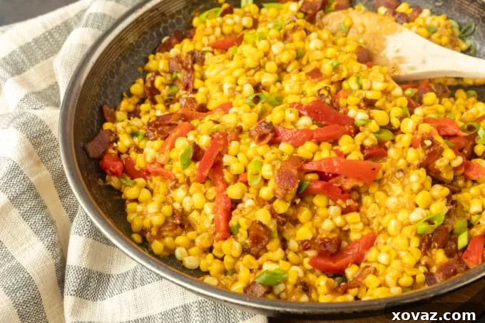 Skillet-Fried Sweet Corn 3 fried sweet corn with bacon, green onions and roasted red peppers in a bowl