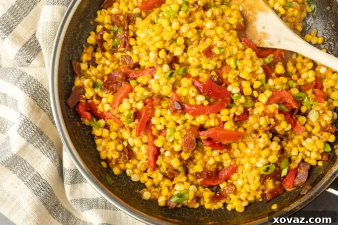 Skillet-Fried Sweet Corn 5 fried sweet corn with bacon, green onions and roasted red peppers in a bowl